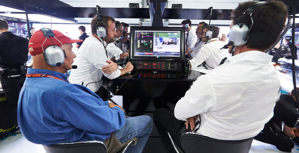 Personal de la F1 discutiendo frente a una pantalla