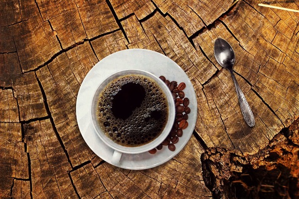 Café americano sobre un tronco de madera